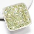 Close-up of translucent light green AB coated cube beads in a white ceramic dish - 8mm / Green