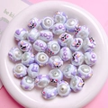Macro detail of hand-painted pearlescent acrylic beads with cartoon animals and bows - Light Blue Pearlescent XOX Letter Style (08) / 16mm