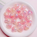 Macro detail of glittery pink acrylic heart beads with colorful iridescent UV finish - 18*22mm / Pink