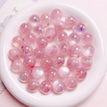 Detailansicht von rosa schillernden Acrylperlen mit UV-Aurora-Beschichtung für Schmuck - 16mm Durchmesser 3mm Loch / Rosa