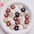 Macro detail of 20mm flower acrylic beads in cream and brown for DIY jewelry making - Mixed Coffee