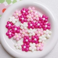 Macro view of 20mm acrylic flower beads in pink and white for DIY craft making - Rose Red & White