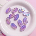 Macro shot of cloud-shaped iridescent purple beads with embossed Cute lettering for DIY crafts - Luminous Purple