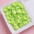 Macro shot of green acrylic lily-of-the-valley flower beads for DIY jewelry making - Sold per piece / Green