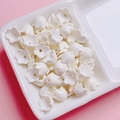 Detailed view of cream-colored lily of the valley acrylic beads for DIY jewelry making - Sold per piece / Off White