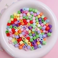 Colorful 7mm square acrylic beads in a white bowl for DIY mobile chain making - 100Pcs Per Pack / Multicolor