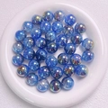 Cuentas degradadas UV 16mm azul con efecto aurora sobre bandeja de cerámica - 16mm / Azul oscuro degradado
