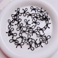 Bulk black alloy bow-shaped charms with metallic finish for DIY jewelry and phone chains - Black
