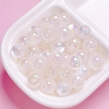 Macro shot of iridescent aurora white acrylic beads for DIY jewelry and phone chains - 10mm / White
