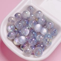 Macro detail of iridescent UV coated acrylic beads with cat eye luster for DIY crafts - 10mm / Gray
