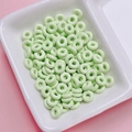 Mint green donut beads in a ceramic tray for DIY jewelry and phone chain making - Light Green