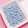 Macro view of light blue glazed donut-shaped beads for DIY jewelry making accessories - Light Blue