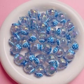 Vue macro de perles de tortue bleu clair translucides avec paillettes étincelantes - 16mm / Bleu