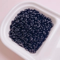 Glossy black acrylic twin-hole seed beads in a white bowl for DIY jewelry making - 200 Pieces/Pack (Approx. 4x6mm) / Glossy Black