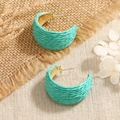 Detailed macro of mint green raffia wrapped C-shaped hoop earrings with gold metal base - Lake Blue