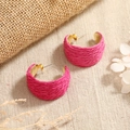 Detailed shot of pink raffia woven C-shaped hoop earrings with gold metal base - Rose Red