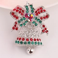 Detail of Christmas bell brooch featuring red and green rhinestones and silver bow - Silver