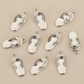 Flat lay of 10 silver flip-flop charms for DIY jewelry making on beige fabric background - Single Flip-Flop Design / Silver Style 1