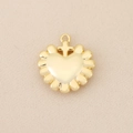 Macro detail of 18k gold plated heart pendant with central cross and relief edge - Gold