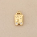 Macro shot of 18k gold luggage pendant with airplane embossing and diamond wheels - Gold