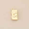Close-up of a 18k gold plated rectangular pendant featuring a 3D bowknot design and ring - Gold