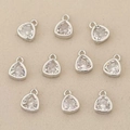 Macro detail of ten silver pendant connectors with clear zircon stones for DIY jewelry making - Silver Oval