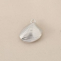 Gros plan sur pendentif coquille argenté avec texture radiale pour la création bijoux - Argent