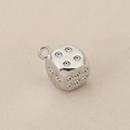 Macro shot of silver dice pendant with zircon crystals for DIY jewelry making - Silver