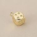 Macro shot of a 18K gold plated dice pendant showing polished metal texture and ring - Gold