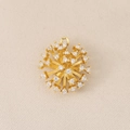 Macro detail of gold-plated sunburst pendant with micro-paved cubic zirconia - Gold