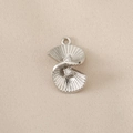 Close-up of a silver fan-shaped pendant with radial stripes and clear crystal stones - Silver