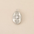 Detailed macro view of vintage oval silver pendant with centered sparkling cubic zirconia stone - Silver