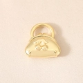 Macro detail of 18K gold plated handbag charm with embossed cherry pattern and vintage design - Gold (PJ0585)