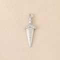 Detailed macro of a silver dagger pendant with zircon stones on a soft fabric background - Silver
