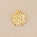 Macro view of gold round pendant featuring lotus relief and small white zircon inlay - Gold