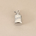 Close-up of geometric milk carton pendant with sparkling zircon inlays and straw detail - Silver