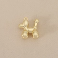 Close-up of a 18K gold-plated balloon dog pendant with a high-shine mirrored finish - Gold