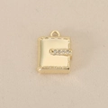 Detail of 18k gold plated book pendant featuring shimmering cubic zirconia accents - Gold