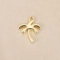 Detailed macro view of gold-plated palm tree pendant on a textured beige fabric background - Gold