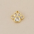Detailed macro view of 18K gold paw print pendant with sparkling heart-shaped zircon stones - Gold