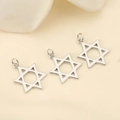 Macro detail of three polished silver hexagram pendants for DIY jewelry crafting - Silver