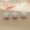 Detailed macro view of three silver hollow heart-shaped metal beads for DIY jewelry making - Silver