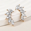 Detail of gold wing earrings featuring marquise-cut crystal rhinestones in prong setting - White