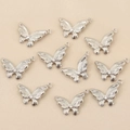Vue détaillée de dix pendentifs papillon argentés avec zircons pour la création de bijoux - Argent Style 5