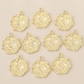 Detailed macro view of ten gold-plated floral relief pendants with wavy edges on silk - Gold Style 2