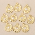 Detailed macro view of ten gold flower pendants with zircons and hammered texture - Tulip Hammered Round Style / Gold Style 1