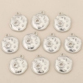 Detail view of 18k gold plated sun and moon charms with zircon insets on beige fabric - Irregular Round Sun Moon Style (Silver Style 1)