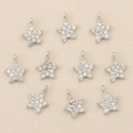 Macro shot of ten star-shaped silver pendants with micro-pave zircons for DIY jewelry - Pentagram / Silver Style 2