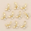 Close-up of 10 gold-plated flower pendants with inlaid crystals for DIY jewelry making - Gold Flower Style