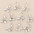 Detailed view of silver flower charms with inlaid zircons for DIY jewelry making - Silver Flower Style